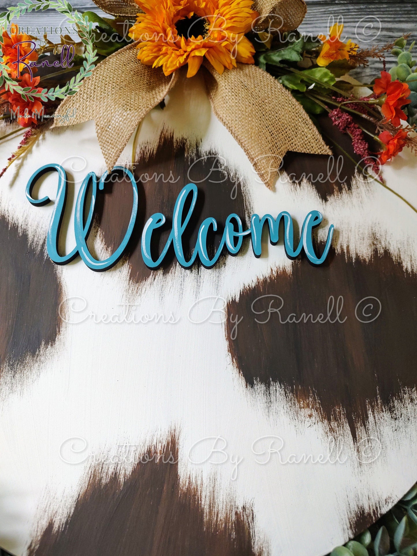 Cowhide door hanger with sunflower and bow. Hand-painted, one-of-a-kind welcome door hanger and sign. Love cows? You'll love this!