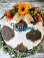 Cowhide door hanger with sunflower and bow. Hand-painted, one-of-a-kind welcome door hanger and sign. Love cows? You'll love this!