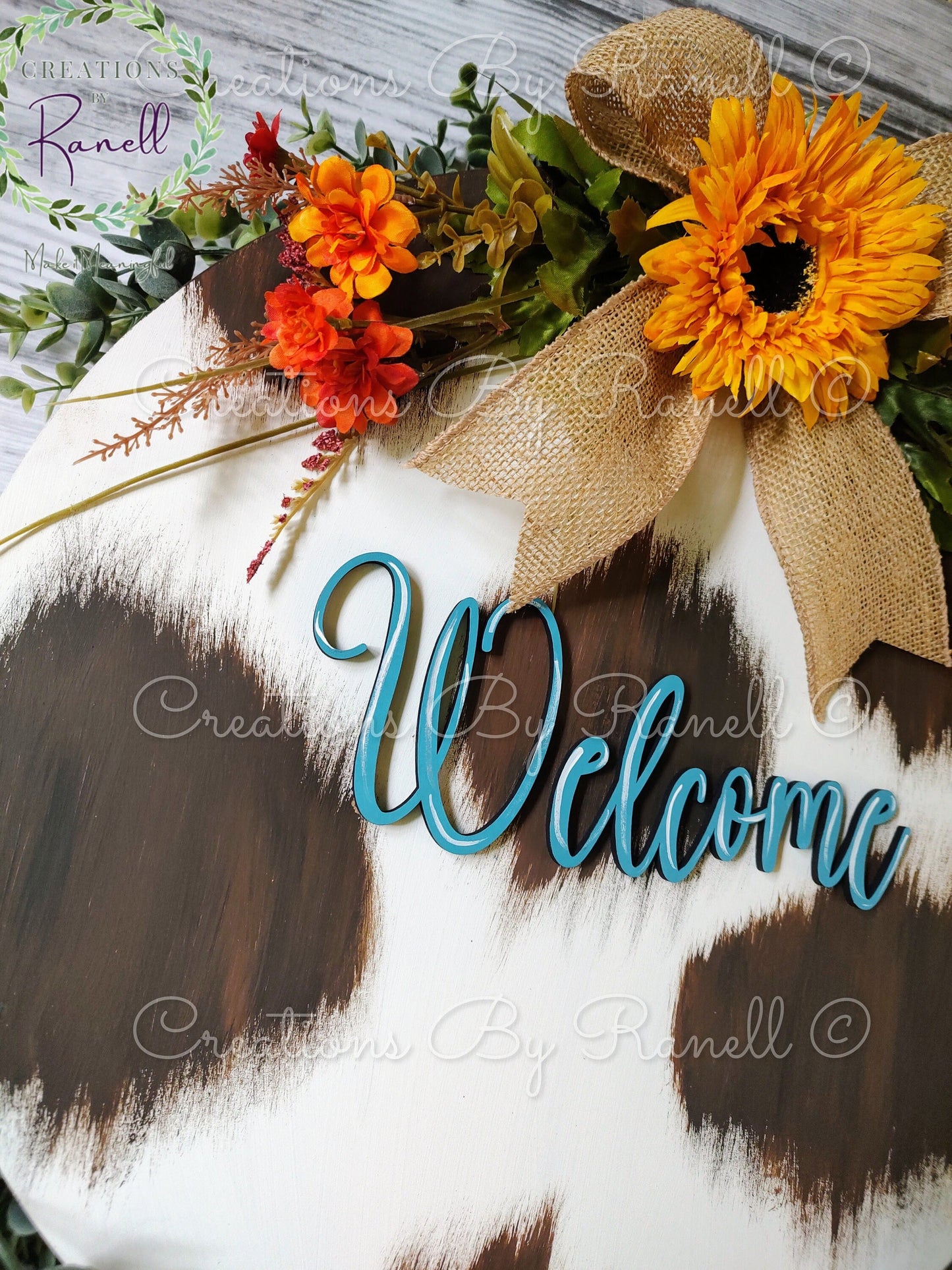 Cowhide door hanger with sunflower and bow. Hand-painted, one-of-a-kind welcome door hanger and sign. Love cows? You'll love this!